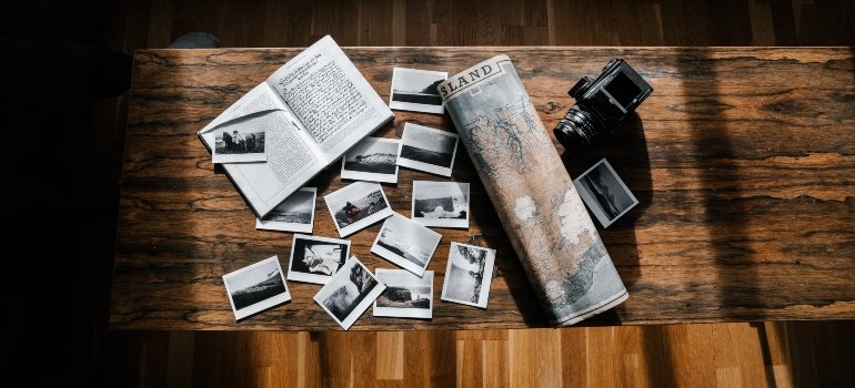 Arranged old photos on a wooden table.