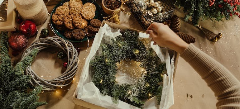 A person packing Christmas items for storage