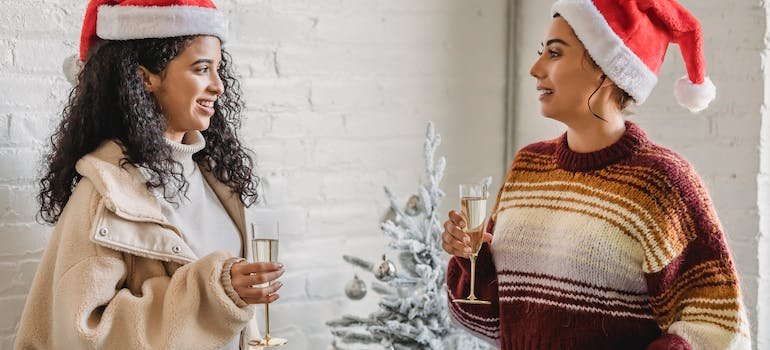 Two people holding champagne glasses and talking about their need to rent a storage unit during the holidays
