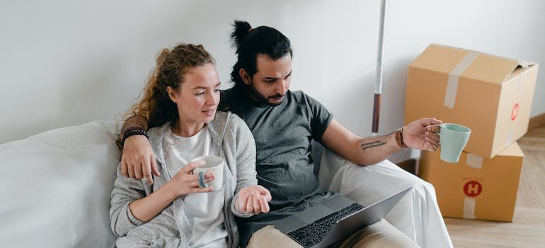 A couple using a laptop to look for West Village storage units