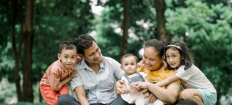 A family sitting in the park after discovering the best kids acitivties near Highbridge
