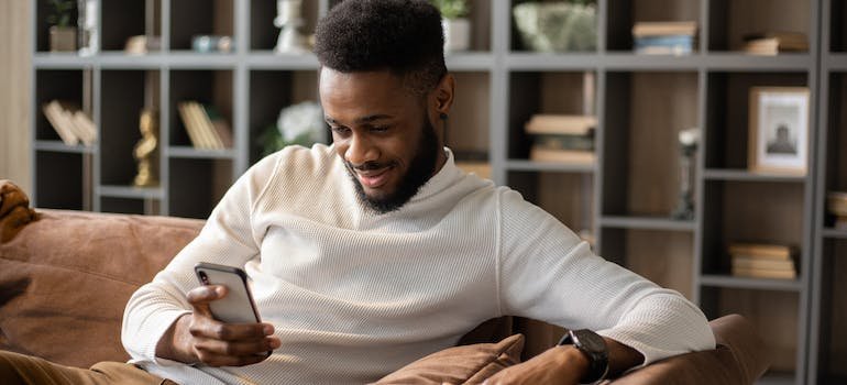 A person using their smartphone to search for storage units Fordham NY residents recommend
