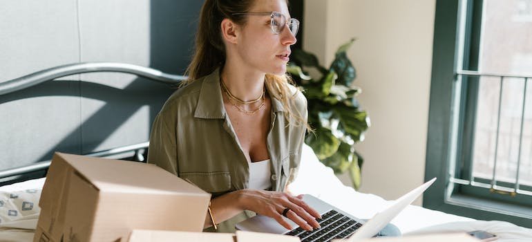 A person using their laptop to look for self storage Parkchester locals recommend.