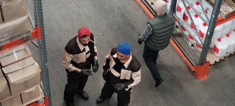 three people in a storage facility
