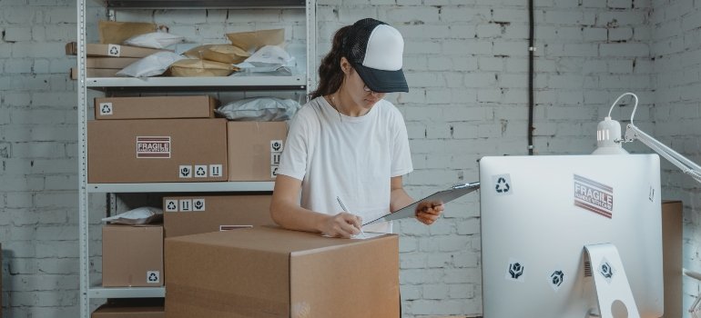 A person calculating the price for the perfect storage unit size.