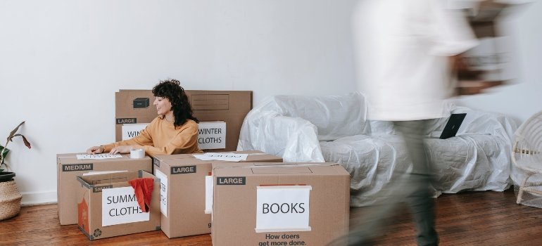 A person among several cardboard boxes