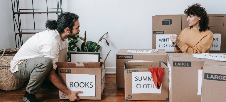 A couple delcuttering their belongings after finding out that storage units can expand your apartment.
