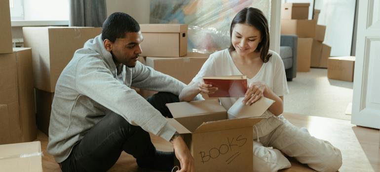 A couple packing their items after deciding to choose Bronx self storage.