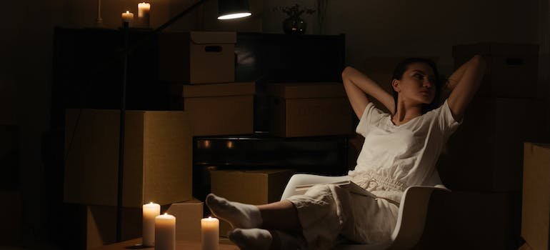 A person relaxing in a semi-dark rook