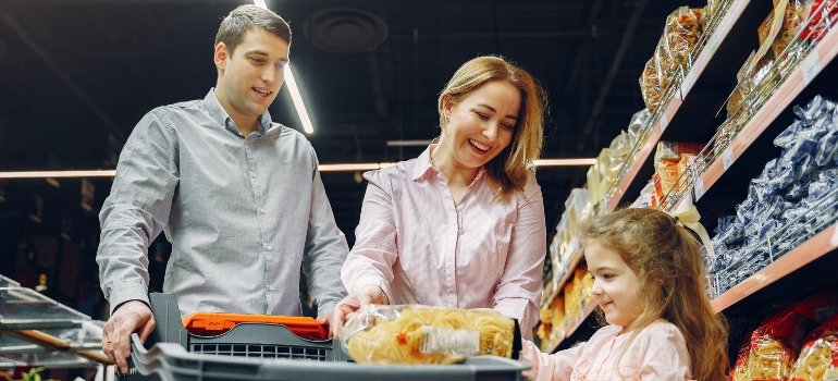 A family grocery shopping after their move to Castle Hill.