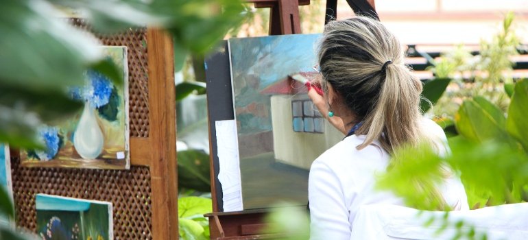 A person painting after safely putting her other belongings in a storage unit of a Manhattan storage provider.