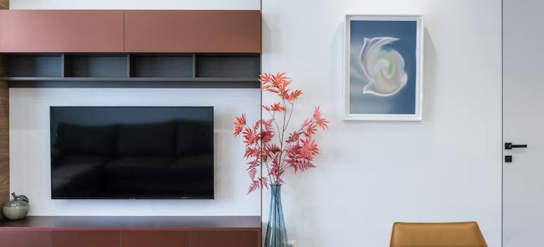 A TV set with shelves above it