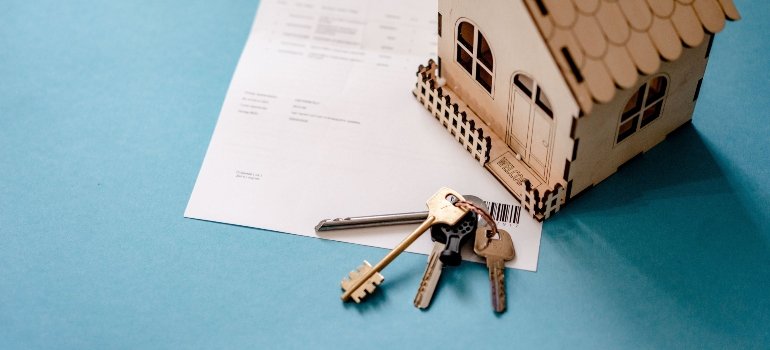 Keys and a contract on a table.