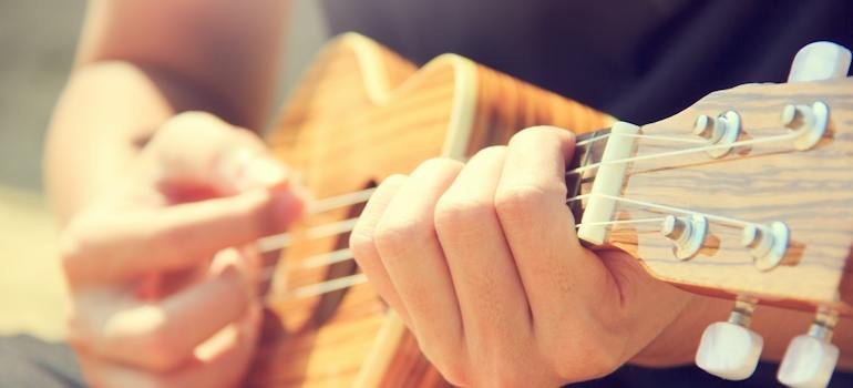 A person playing a small guitar.