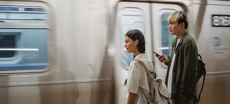 A young couple using the subway