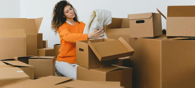 A person preparing items after choosing the perfect storage unit size