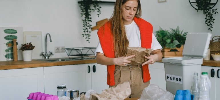 A person decluttering their kitchen before looking for a reliable Manhattan storage provider