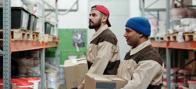 A storage unit with people helping you manage moving day challenges.