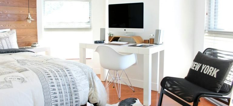 Room in a new apartment with a bed, working corner and decoration.