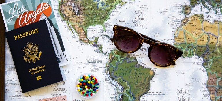 A world map, a passport, and sunglasses.