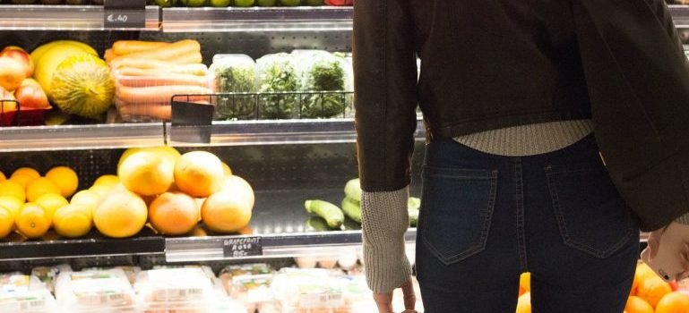 Woman looking at the fruits and vegetables at a store