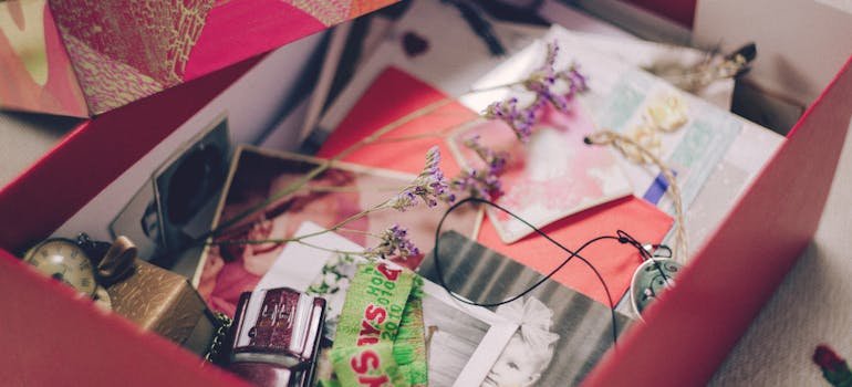 A box filled with sentimental images and various knick-knacks.