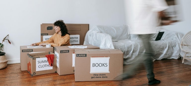 A couple rearranging a room.