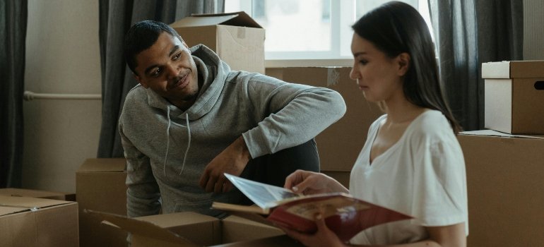 A man and his wife surrounded with moving boxes before moving from Wakefield to Castle Hill.