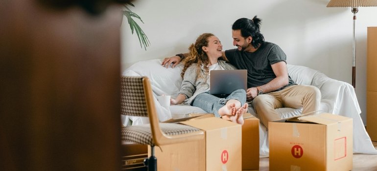 A couple sitting on a couch after moving to Morningside Heights.
