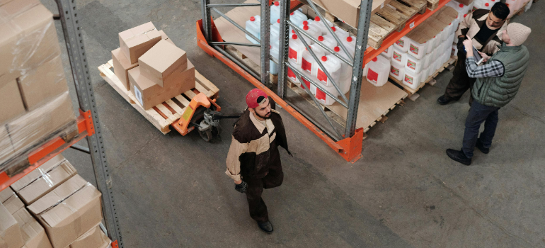 A man in a storage facility after realizing that renting storage units boosts business productivity