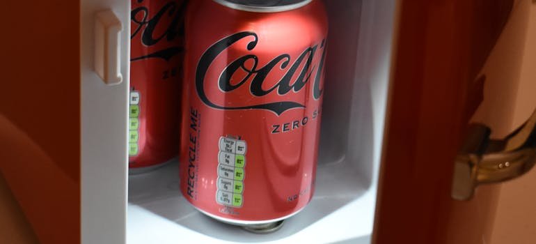 Coca cola can in the mini-fridge, which is one of the things that are required for a New York City apartment.