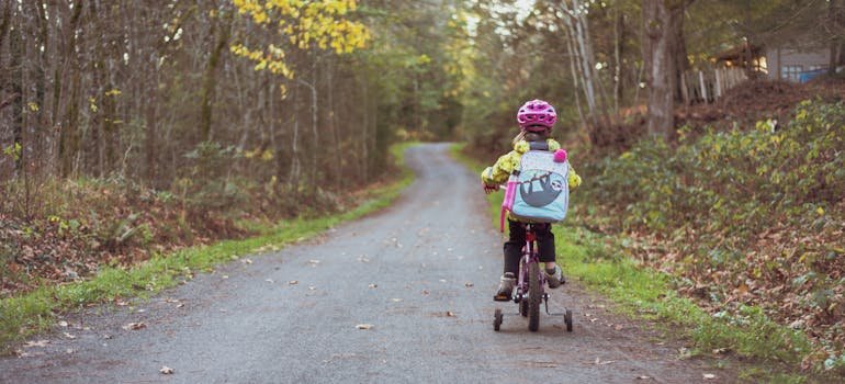 A little girl riding her bike after moving from Longwood to Parkchester.
