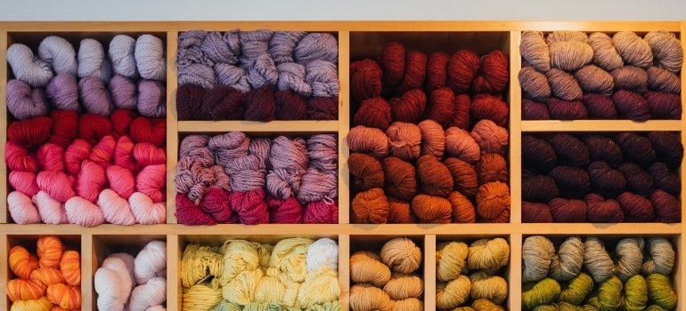 A shelf with yarn in different colors.