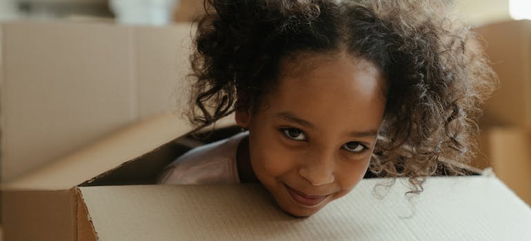 A girl peeking out of the box