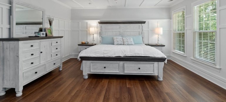 A white double bed with drawers