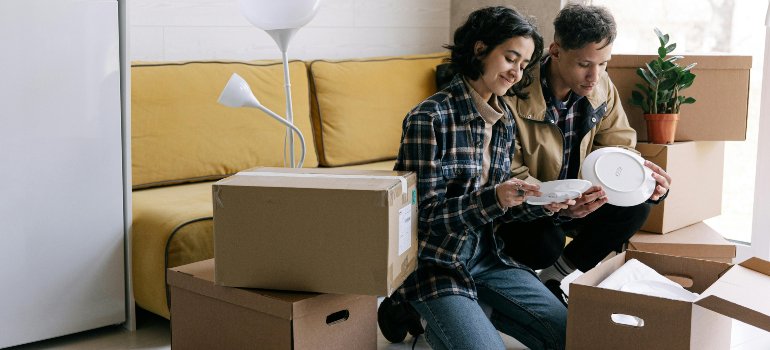 A couple trying to settle into their new apartment while applying small space solutions for urban living in Manhattan
