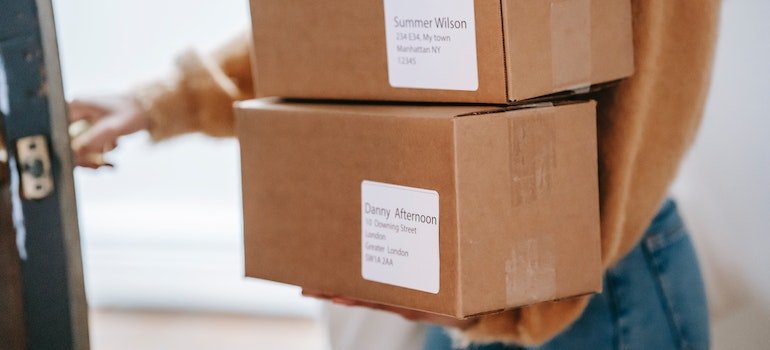 A woman carrying boxes