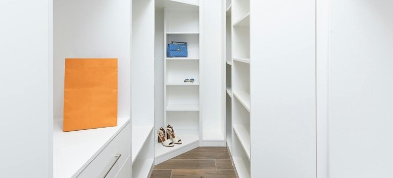 White shelves in the corner of the closet