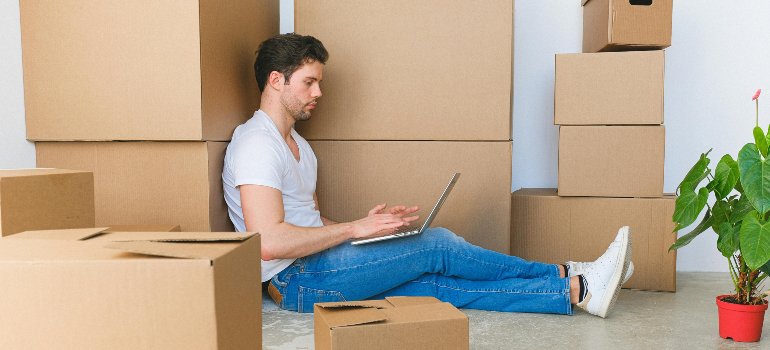 A man searching for affordable storage solutions in the Bronx on his laptop.