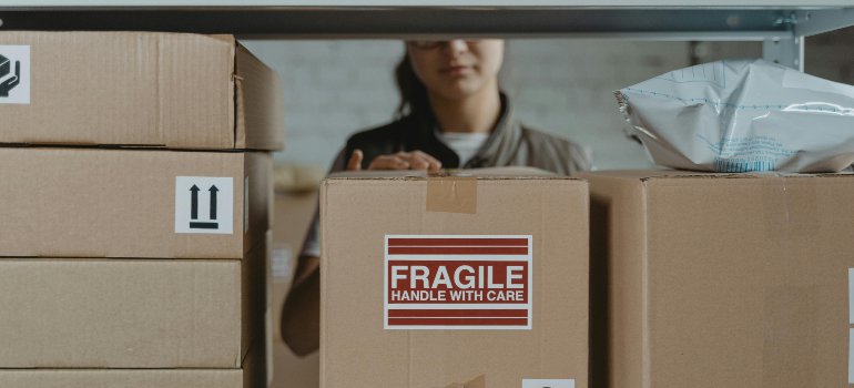 A girl who knows the psychological effects of decluttering and storage rental storing boxes.
