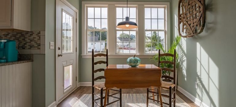 A dining room with big brown table and two chairs.
