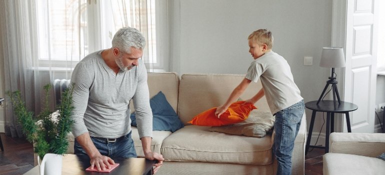 A son and father keeping a big home clean and organized.