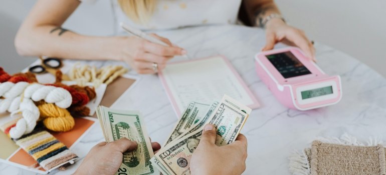 A person counting money and explaining why Manhattan renters should consider storage