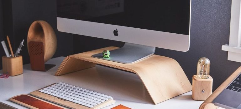 A well-organized desk with a computer and pencils.