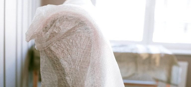 A part of furniture covered with bubble wrap.