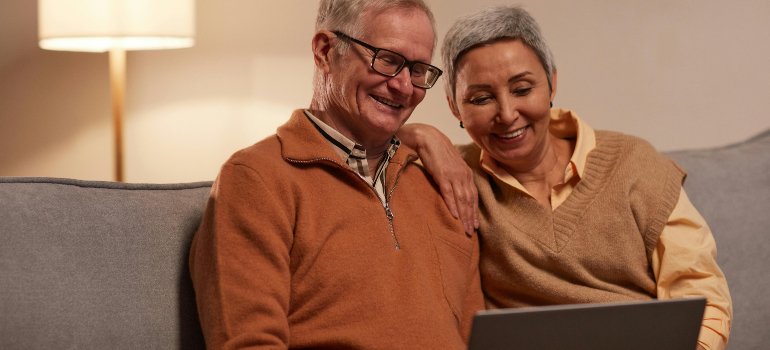 An elderly couple trying to find affordable storage units in Manhattan online.