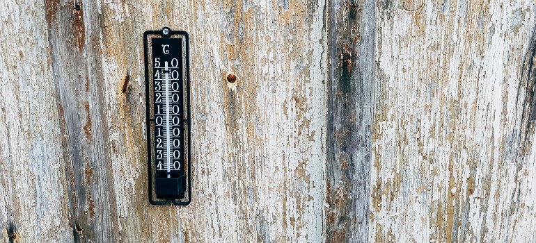 A thermometer on a wooden surface.
