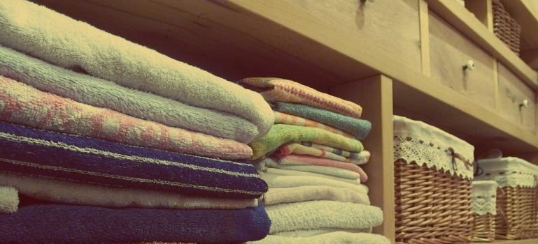 Stacks of towels on a shelf in a bathroom