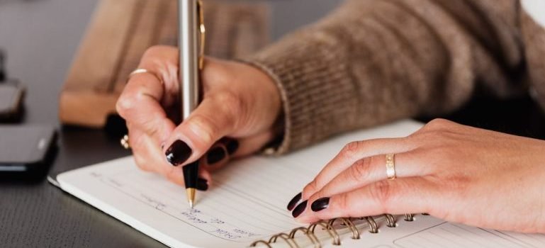 A woman writing down some notes