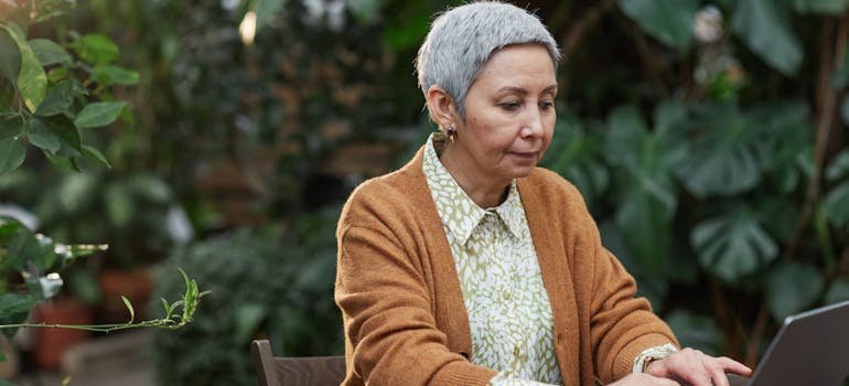 A woman reading on a laptop about storage solutions for senior citizens